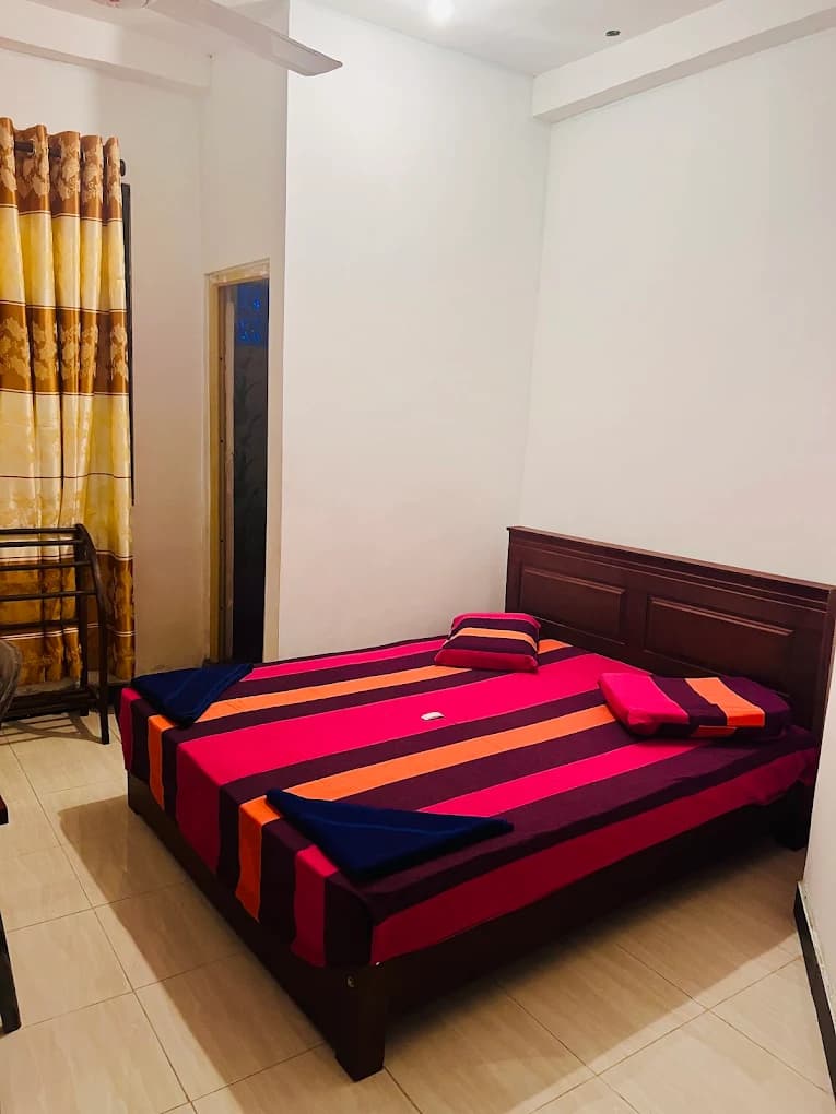 Guest room with a double bed and wooden headboard